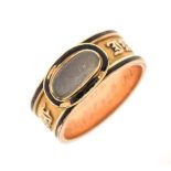 Regency yellow metal and black enamel mourning ring set central oval cabochon, possibly rock