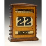 Early 20th Century oak-cased desk calendar with rollers for day, date and month, 29.5cm high