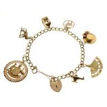 9ct gold curb-link charm bracelet set six assorted gold and yellow metal charms plus a padlock, 16.