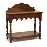 Early 20th Century oak side table having carved back and mask head handle to the single drawer