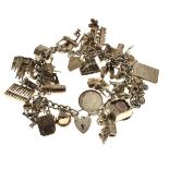 Silver curb-link charm bracelet with assorted silver, white metal and unmarked charms