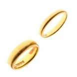 Two 22ct gold wedding bands, size J and L respectively, 10.6g approx (2)