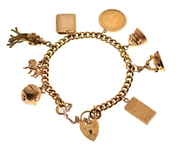 18ct gold curb-link charm bracelet set eight various charms to include; a half sovereign 1912 and