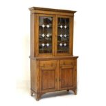 Early 20th Century oak two section bookcase having leaded glass doors, 106cm wide