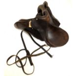 Brown leather 17-inch horse saddle, together with reins