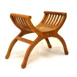 Walnut X framed stool having cane seat