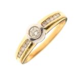 Yellow metal and diamond dress ring with larger central stone between smaller diamonds to shoulders,