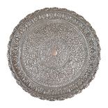 Indian white metal salver, having allover embossed floral decoration standing on four scroll feet,