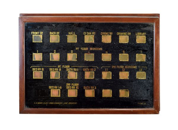 Early 20th Century servants bell call box, the rectangular verre eglomisé panel of twenty-six