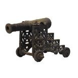 19th Century cast iron folly-cannon, with ringed 44cm barrel on pierced stepped carriage with