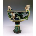 Hugo Lonitz & Co majolica pedestal bowl, the handles formed as winged maidens, each emerging from