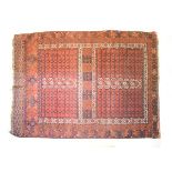 Early to mid 20th Century Middle Eastern (Turkoman) wool rug, the brick-red field having rectangular