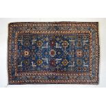 Middle Eastern (Persian) wool rug, the cobalt blue field with allover palmettes, flower heads and