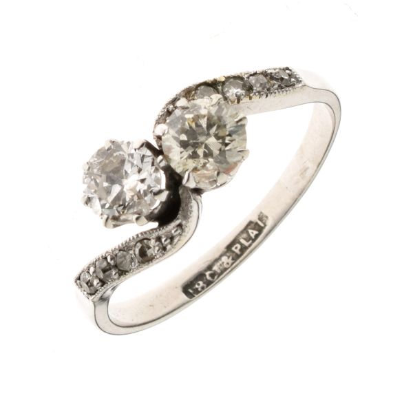 Two stone diamond crossover ring, the white metal stamped '18ct' and 'Plat', the brilliant cuts