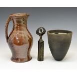 Three items of Studio pottery, comprising a brown-glazed stoneware jug of ribbed bulbous form with