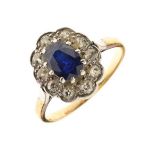 Sapphire and diamond cluster ring, unmarked, the oval cut sapphire approximately 6.9mm x 4.8mm x 3mm