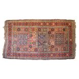 Middle Eastern (South Caucasian) wool rug, the brick-red field with three hooked rectangular