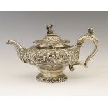 Victorian silver squat circular teapot, with allover classical embossed decoration and scroll