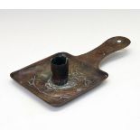 Newlyn copper chamber candlestick, having embossed decoration of two stylised fish and stamped