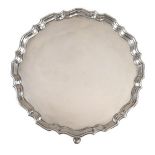 George V silver salver, with pie crust edge standing on triple pad feet, sponsors mark of