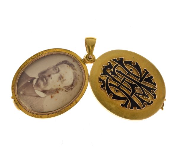 Victorian gold locket, with applied black enamel monogram, swing open action, containing a