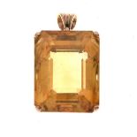 Large single stone citrine pendant, in an unmarked gold coloured four claw mount, the step cut stone