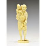 Japanese Meiji period carved ivory okimono, of an old man, a young child on his back holding a