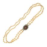 Graduated two row cultured pearl necklace, to a Victorian foil backed stone and seed pearl set