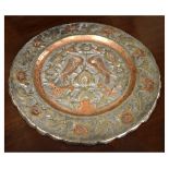 Middle Eastern silvered copper plate, relief-decorated with birds and flowers, 33cm diameter