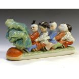 Modern Chinese porcelain figure group of five children attempting to uproot a giant vegetable,