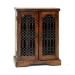 Reproduction hardwood Maharani style cabinet fitted two metal grilles opening to reveal CD
