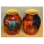 Pair of Poole Pottery vases of ovoid form with typical red and orange glaze, 20cm high