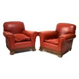 Pair of 20th Century oak framed fireside armchairs upholstered in red hide