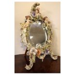 Late 19th Century Continental porcelain dressing table mirror, the bevelled oval plate within high