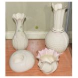 Four items of Irish Belleek (Co. Fermanagh) porcelain comprising: two vases, pots and candle