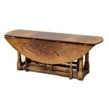 Good quality reproduction oak oval drop-leaf coffee table, 118cm wide, flaps down