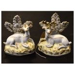 Pair of 19th Century porcelain figures of recumbent deer with bocage and gilt highlights, a stag and