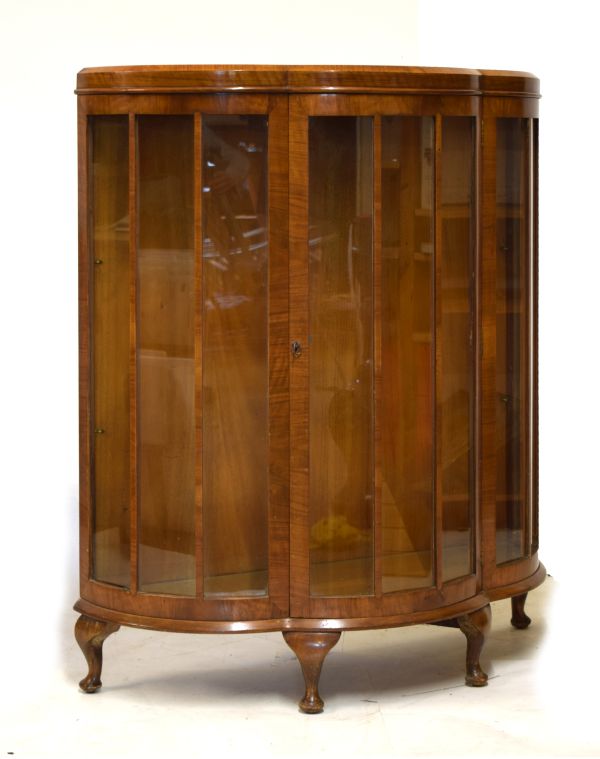 Early 20th Century walnut bow front display cabinet fitted two glass shelves enclosed by a glazed