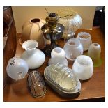 Assorted lighting to include; oil lamp, glass shades, industrial lights etc