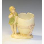 Wahliss (Royal Vienna) figural vase modelled as a child standing beside a giant egg, pad mark