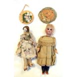 20th Century German bisque headed doll of a young girl along with smaller fabric doll