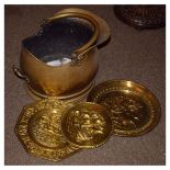 Victorian brass coal helmet, together with two brass dishes and a plaque (4)