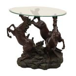 Modern figural cast resin glass topped occasional table modelled as three prancing horses, 60cm