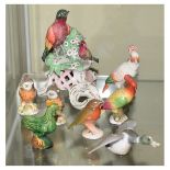 Group of porcelain bird figurines to include one with red anchor mark, others with crossed swords