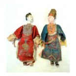 Two Chinese dolls - an Emperor and Empress, each in embroidered clothing