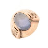 Unmarked yellow metal and single stone star sapphire ring, with oval cabochon approximately 11mm