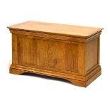Reproduction light oak blanket box having a fitted hinged cover, 91cm wide
