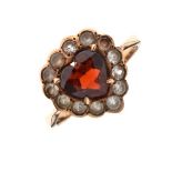 Yellow metal, diamond and red garnet dress ring set central heart-shaped stone within diamond