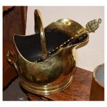 Brass coal helmet with shovel, together with a brass toasting fork