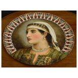 Late 19th Century Continental pottery charger with painted portrait of a lady in gypsy or Eastern